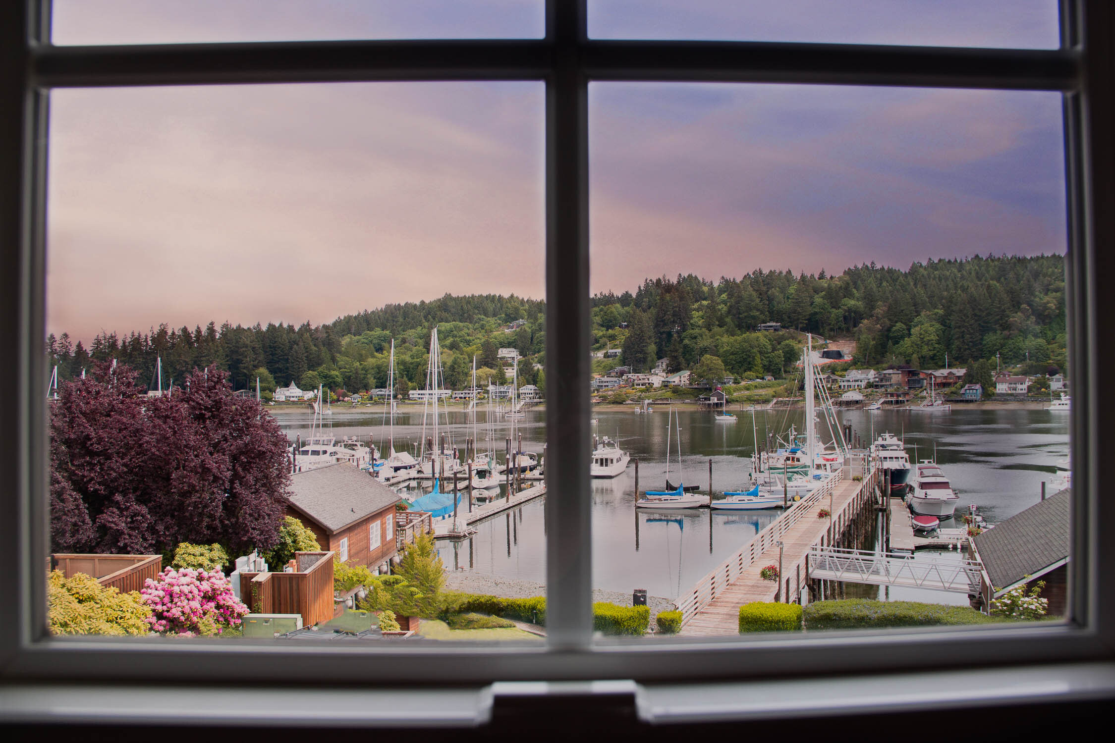 Sunset over the harbor and marina seen through the windows at Brix 25