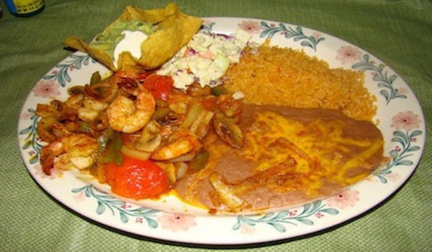 A shrimp plate with Mexican rice, refried beans, guacamole, and tortilla at El Pueblito