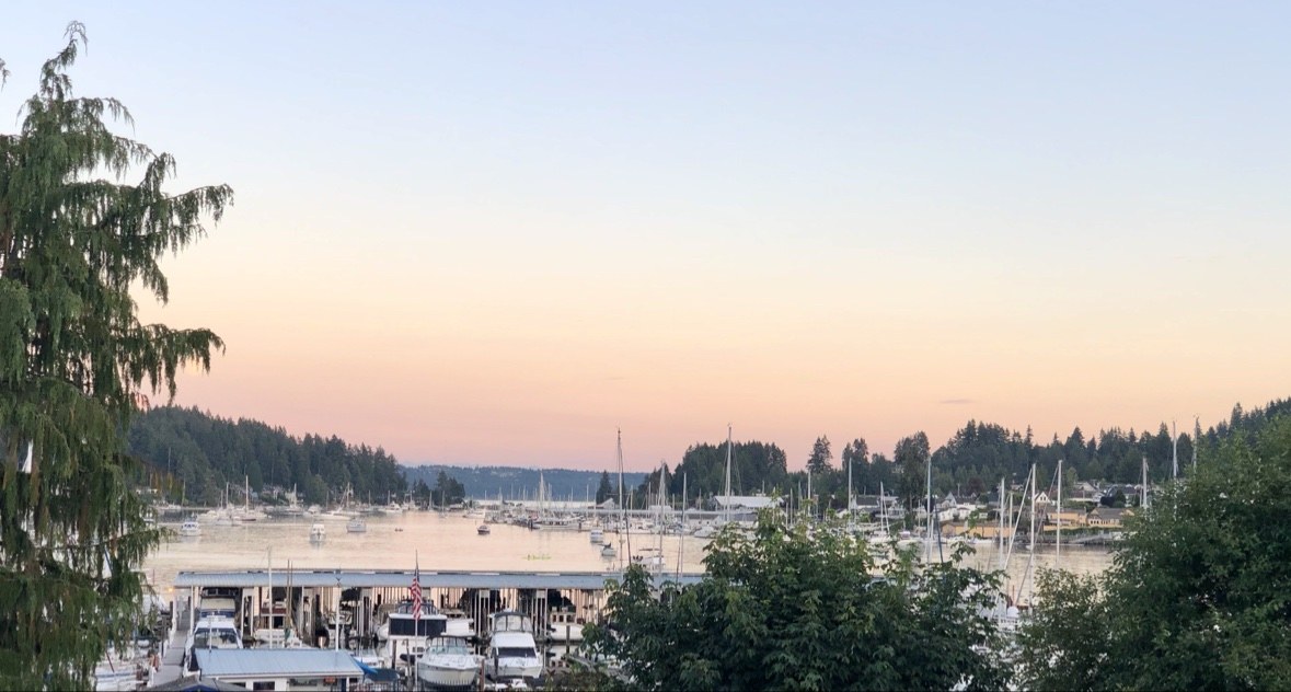 Pink sunset sky over the Gig Harbor marina with boats at anchor
