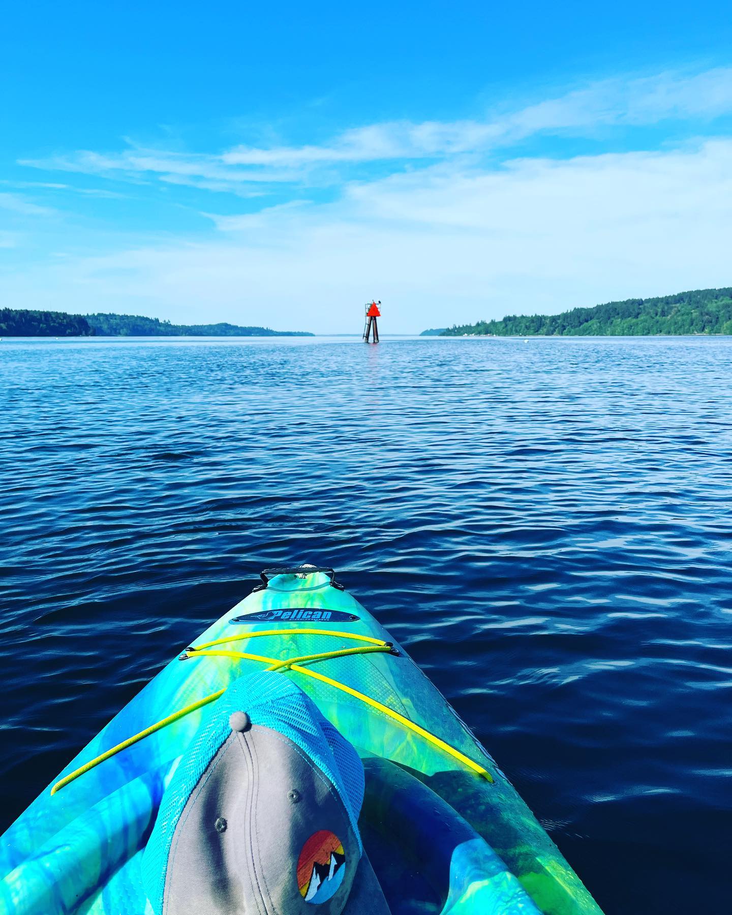 View from a kayak on Olalla Bay looking out toward the channel marker