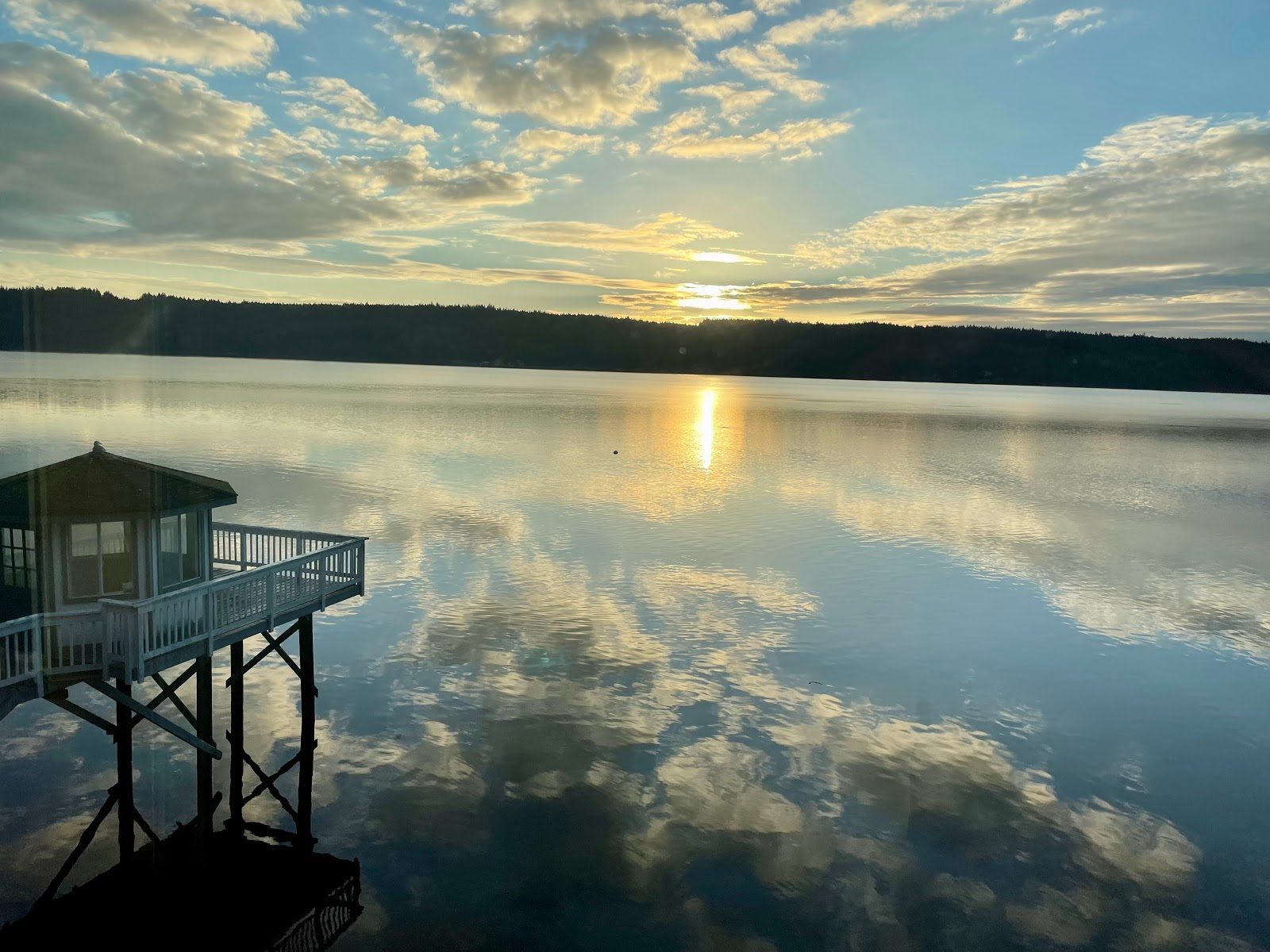 Sunset over glassy water at Olalla Bay with the dock gazebo reflected in the calm surface