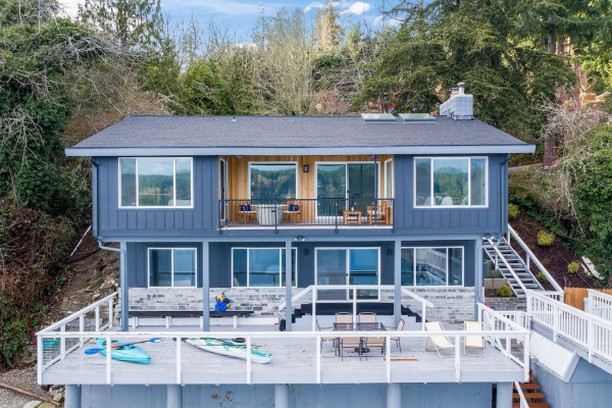 The Olalla Bay beach house with kayaks on the waterfront deck