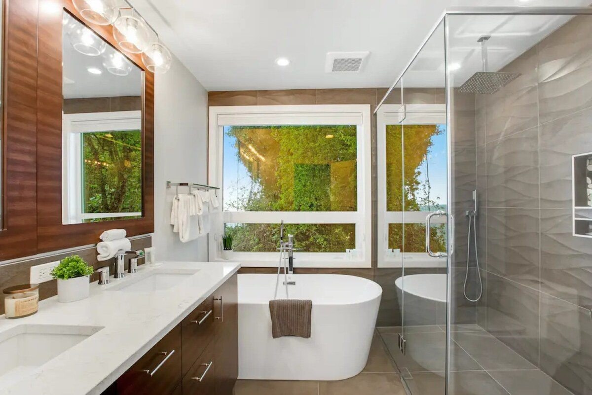 The bathroom today: freestanding tub under a large picture window