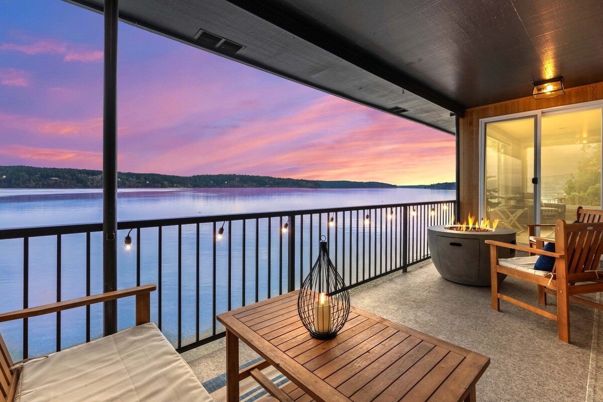 The covered deck today: fire pit and seating at sunset over the bay