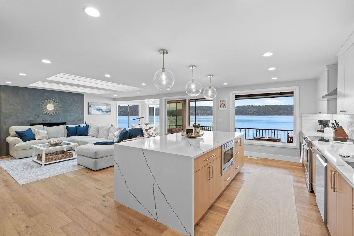 The living room today: open living space and kitchen island with water views