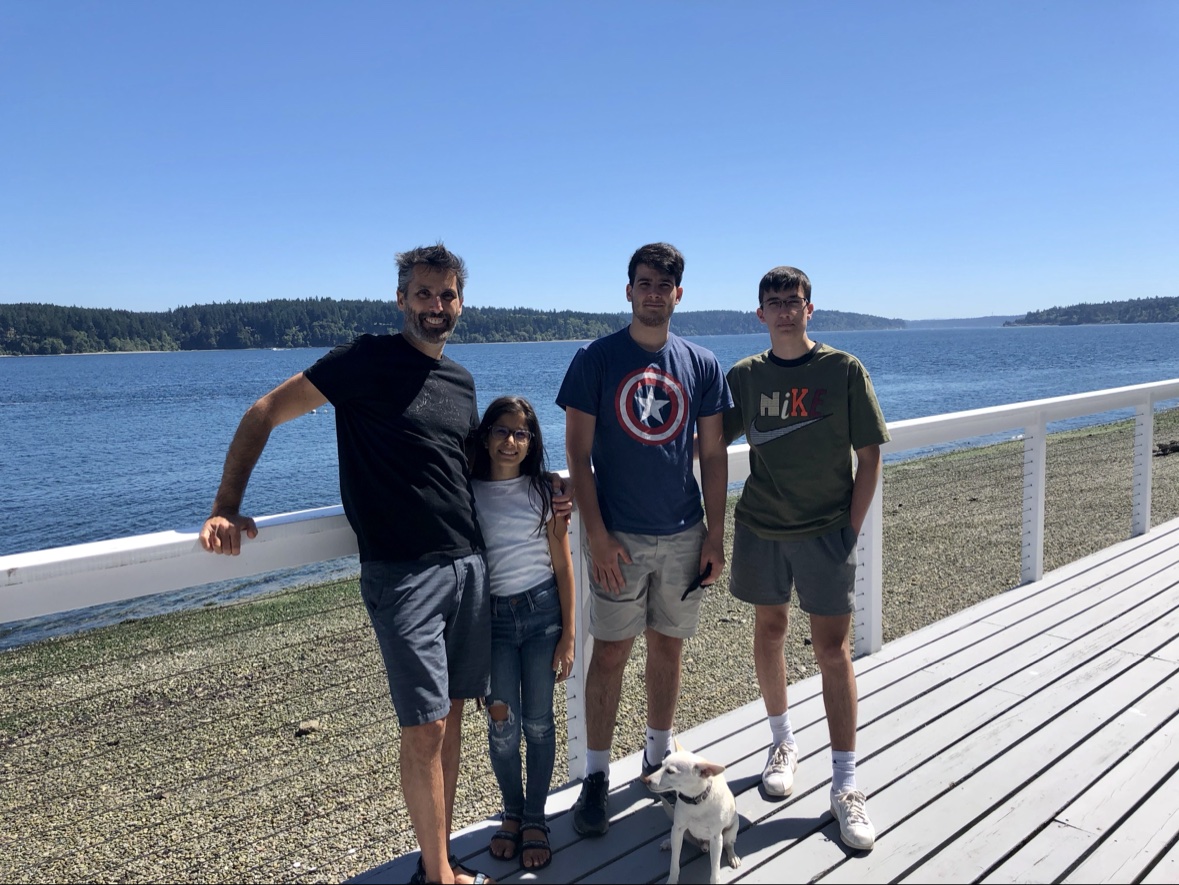 The family on the deck of the house the first weekend, August 2020, with the bay behind them